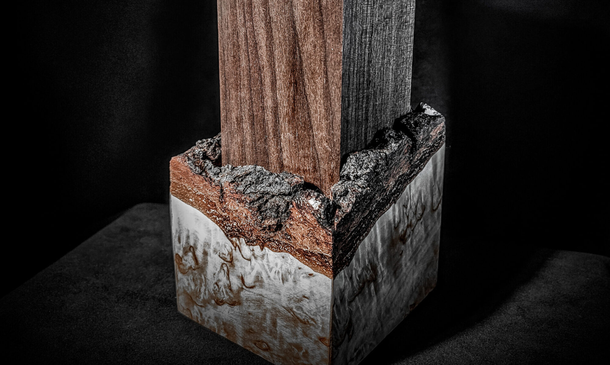 An assortment of beautifully crafted items displayed on a surface, including a decorative Burl Wood Bowl, intricately designed Cutting Boards, and elegant keepsake urns. The rich textures and natural patterns of the burl wood add a touch of sophistication to the collection, showcasing the artistry and craftsmanship of these unique and functional pieces