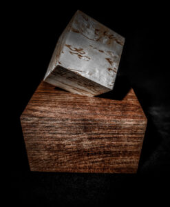 An elegant Wooden Unique Urn for Ashes made of Karelian Birch Burl Wood and American Walnut, featuring a cube upon cube design