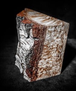 Close-up of Rustic Karelian Birch Burl Wood Cremation Keepsake Urn with a beautiful natural grain pattern and smooth finish.