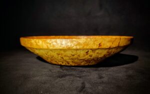 Karelian Birch Burl Wood Decorative Bowl adding a touch of nature-inspired sophistication to a modern, minimalist shelf arrangement.