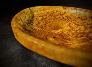 Skilled artisan shaping a Karelian Birch Burl Wood Decorative Bowl, highlighting the handcrafted excellence and dedication to preserving natural beauty.
