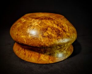 A top-down view of a Decorative Karelian Birch Burl Wood Bowl with a smooth, polished finish. The natural irregularities in the wood grain enhance the bowl's character, creating a distinctive and eye-catching piece.