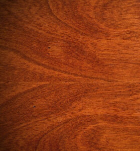 A polished piece of cherry wood, showcasing its warm reddish-brown tones and fine grain. The wood, renowned for its timeless elegance, is often used in furniture and cabinetry. Its natural beauty deepens with age, adding a touch of sophistication to any space. Craftsmen appreciate its workability, allowing for intricate detailing and smooth finishes. Cherry wood is celebrated for its durability, making it a cherished material that stands the test of time in both aesthetics and resilience.