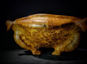 A close-up image of an Oak Burl Wood Bowl, showcasing intricate patterns and textures