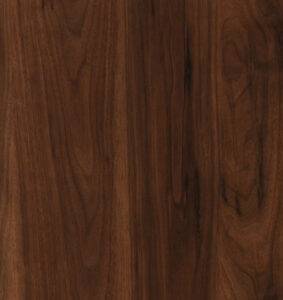 A close-up view of finely crafted walnut wood, showcasing its rich, chocolate-brown hue and swirling grains. The wood is expertly used in furniture and decor, adding a touch of sophistication. Walnut's fine texture invites touch, and its smooth finish enhances the overall aesthetic. Crafted into tables, cabinets, and intricate carvings, walnut wood stands as a testament to both natural beauty and functional artistry, leaving an indelible mark on the world of craftsmanship.