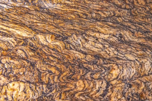 Close-up view of a handcrafted item featuring the intricate patterns and rich colors of rare Buckeye Burl wood, showcasing its unique and natural beauty in artisanal design.
