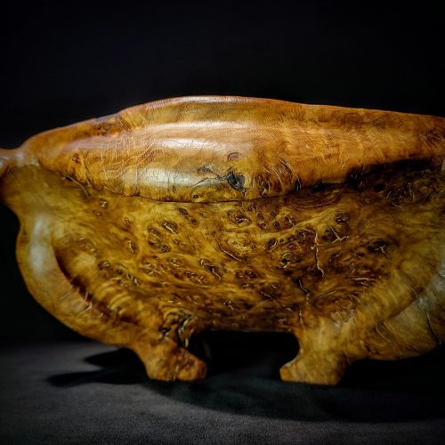 A close-up image of an Oak Burl Wood Bowl, showcasing intricate patterns and textures